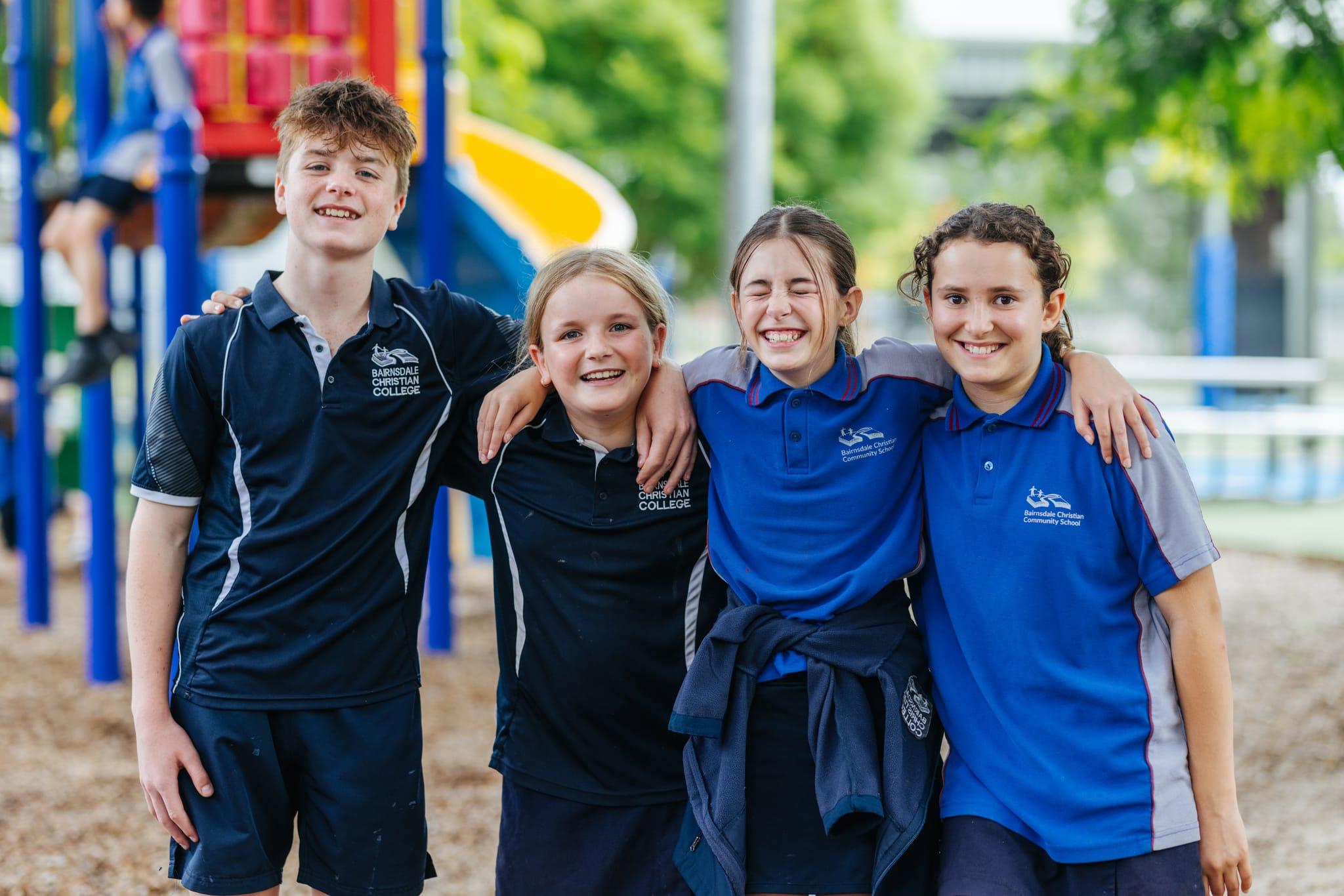 Upper primary and secondary students laughing together in the playground at Bairnsdale Christian College, capturing the joyful and welcoming atmosphere experienced during school tours.