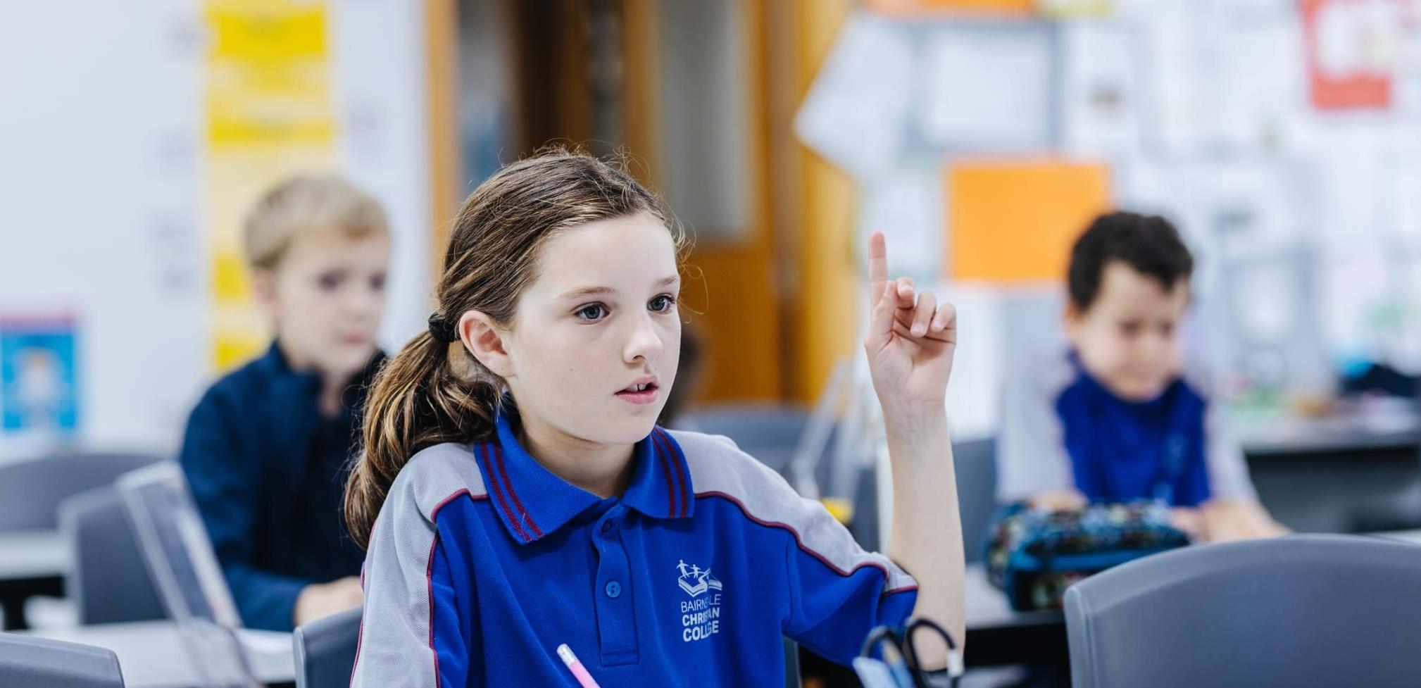 Primary school student actively participating in class at Bairnsdale Christian College, illustrating the supportive and affordable Christian education that encourages confidence and curiosity.