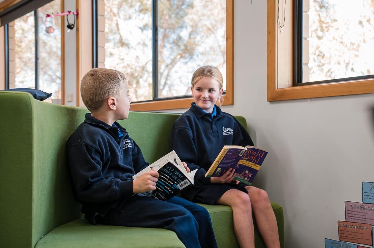Two primary students reading together in a quiet library space at Bairnsdale Christian College, reflecting the nurturing, affordable Christian education.