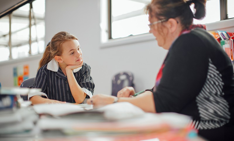 Smiling female student with hair-bow in Somerset library