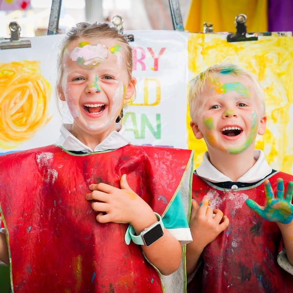 children playing with paint and laughing
