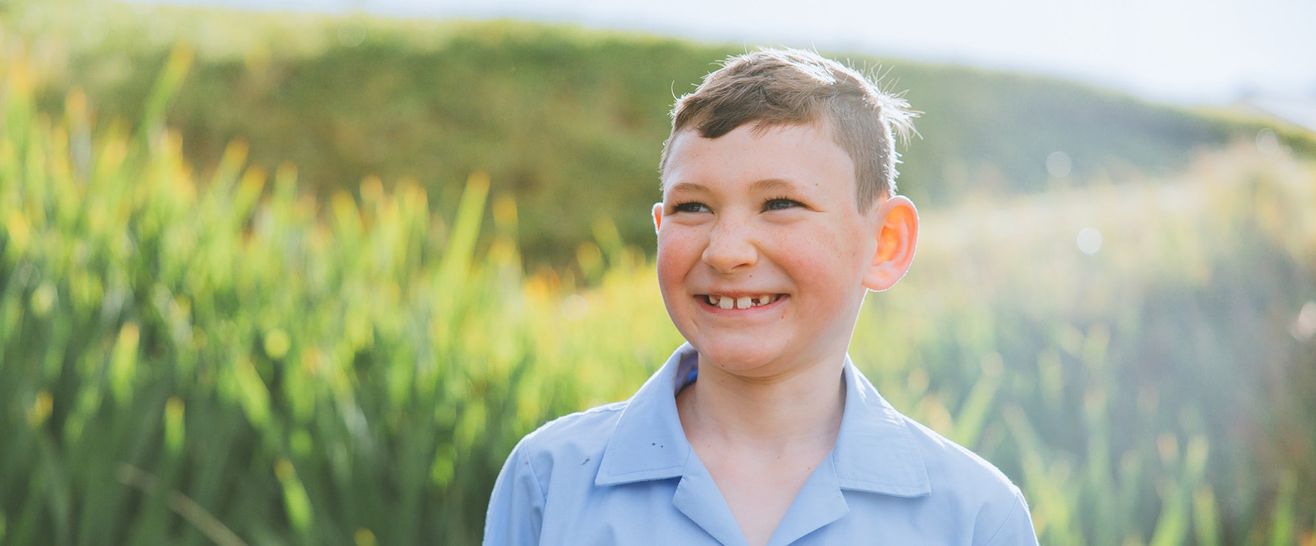 Brightwaters students in light blue uniform walking along Lake Macquarie waterfront