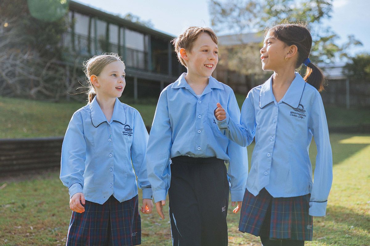 Three female high school students in conversation with one another